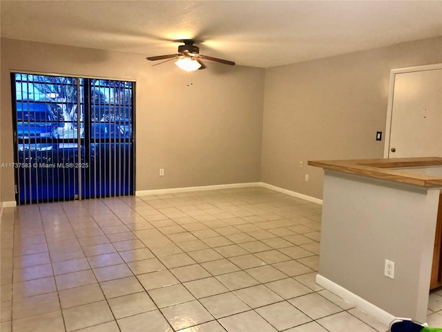 empty room with light tile patterned floors and ceiling fan