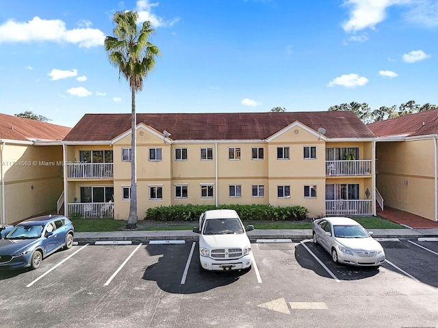 view of building exterior featuring uncovered parking