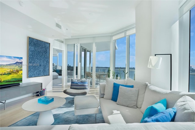 living room featuring hardwood / wood-style floors and floor to ceiling windows