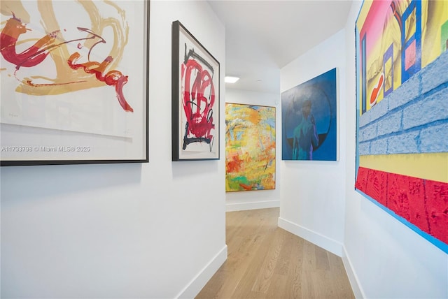 corridor with light hardwood / wood-style flooring