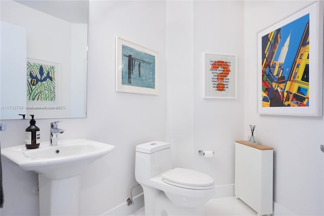 bathroom featuring sink and toilet