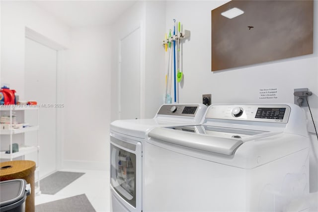 washroom with washing machine and clothes dryer