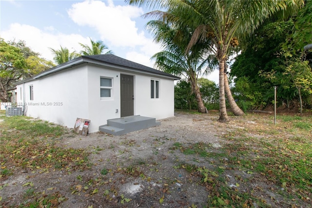 rear view of property with central air condition unit