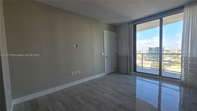 unfurnished room with floor to ceiling windows