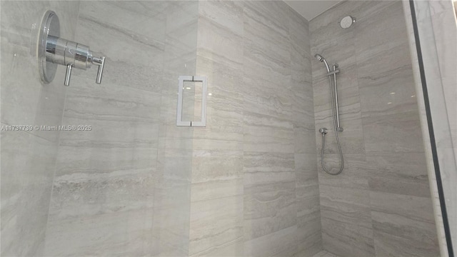 bathroom with tiled shower