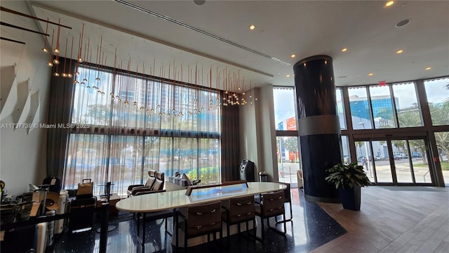 dining room with floor to ceiling windows and hardwood / wood-style floors