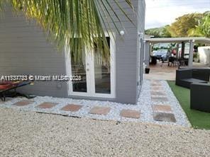 view of exterior entry featuring a patio and french doors