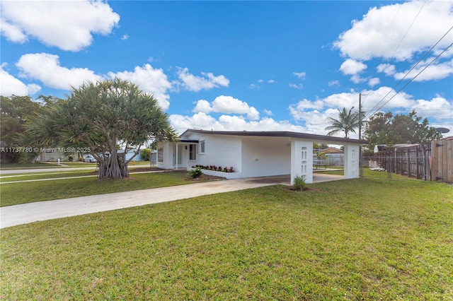 ranch-style house featuring a front yard and a carport