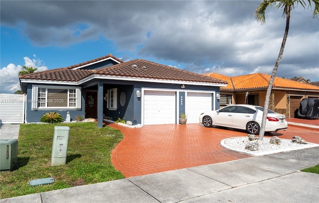 view of front of house featuring a garage and a front lawn