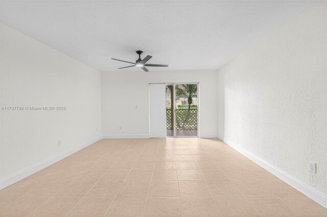 empty room with light tile patterned flooring and ceiling fan