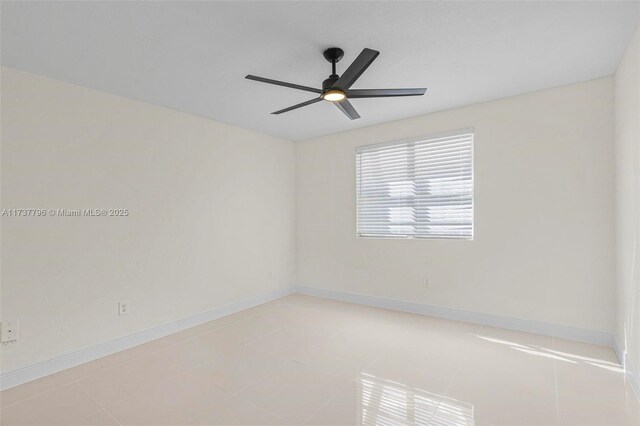 unfurnished room with light tile patterned floors and ceiling fan