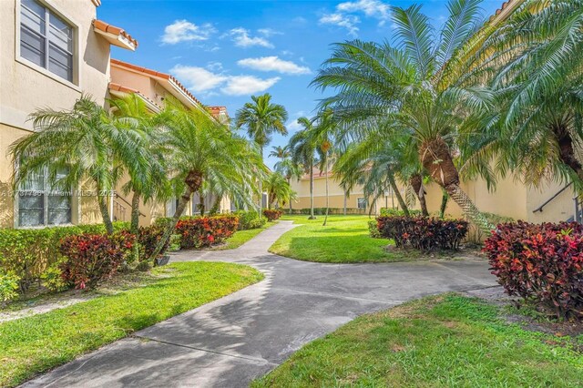 view of property's community with a lawn