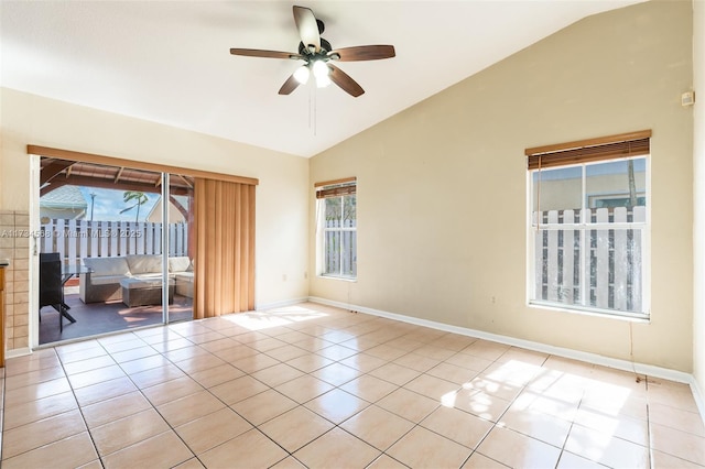 unfurnished room with plenty of natural light, vaulted ceiling, and light tile patterned flooring