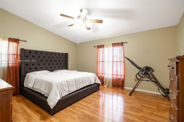 bedroom featuring lofted ceiling, ceiling fan, light wood-type flooring, and baseboards