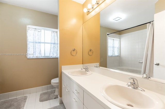 full bathroom featuring tile patterned flooring, toilet, a sink, and baseboards