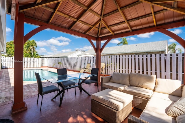 view of patio featuring an outdoor hangout area, a gazebo, a fenced backyard, and a fenced in pool