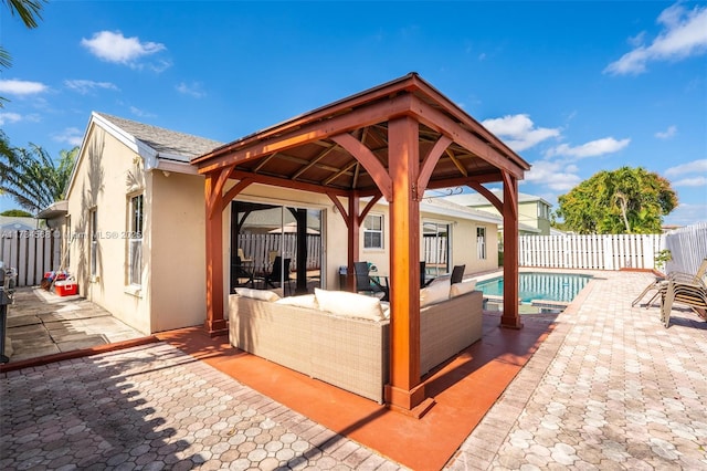 view of patio with a fenced in pool, fence, an outdoor living space, and a gazebo