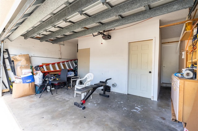 garage with concrete block wall and a garage door opener