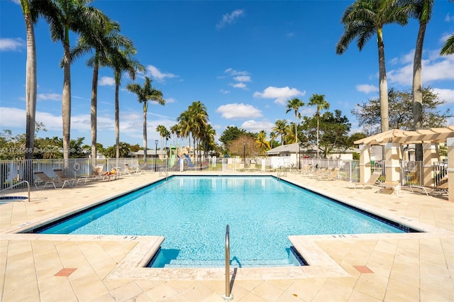 pool featuring a patio area, fence, and a pergola