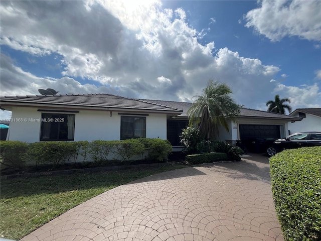 14741 SW 128th Ave, Miami, FL 33186 - ranch-style home featuring a front yard and a garage