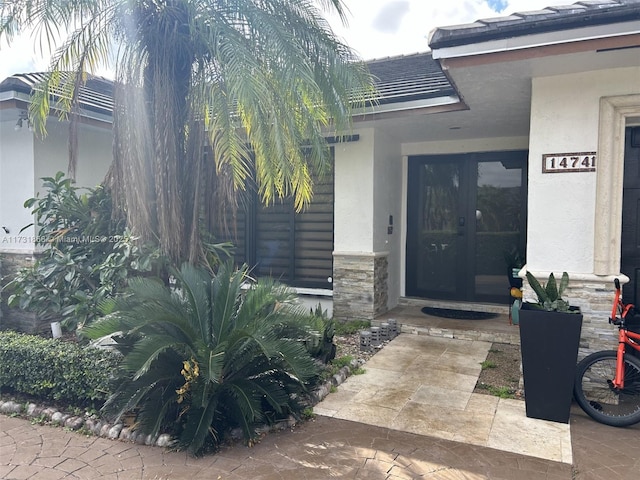 view of exterior entry featuring french doors