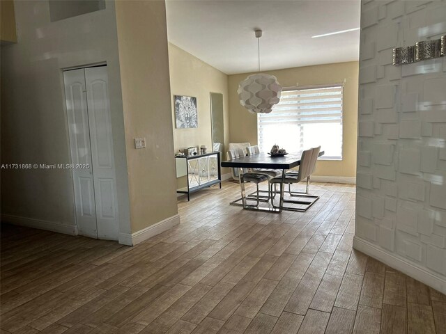 dining space with wood-type flooring