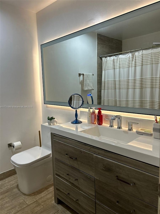 bathroom with vanity, wood-type flooring, toilet, and a shower with shower curtain