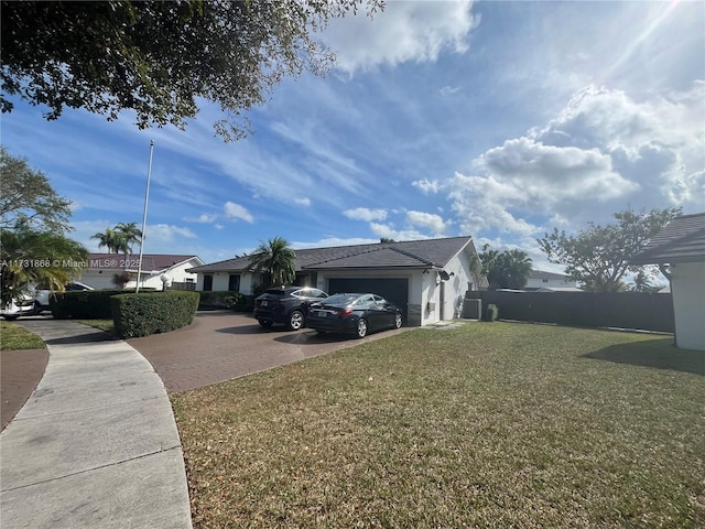 view of side of home featuring a garage and a lawn