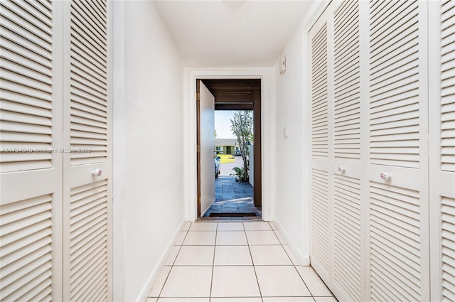 doorway to outside with light tile patterned floors