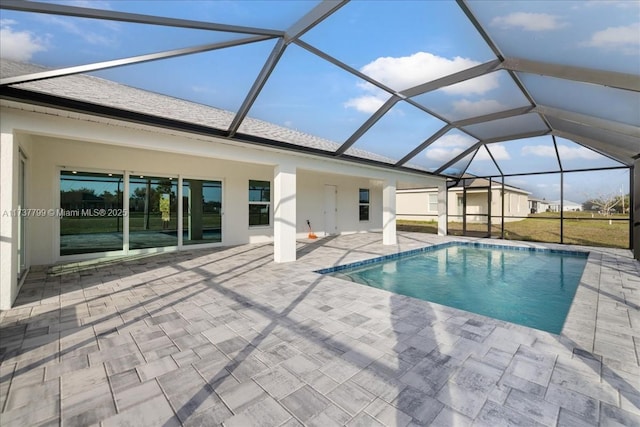 view of pool featuring a patio and glass enclosure