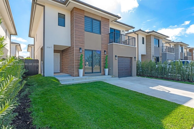 contemporary home featuring a garage, a front lawn, and a balcony