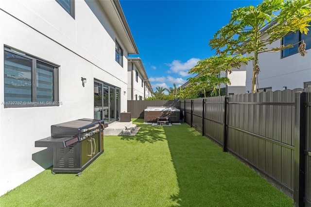 view of yard with a hot tub and a patio area