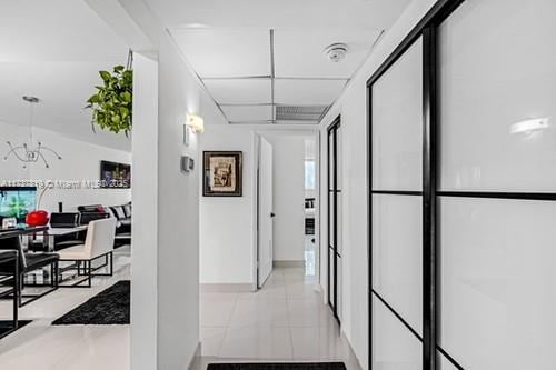 hall featuring light tile patterned floors