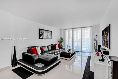 living room featuring a wall of windows