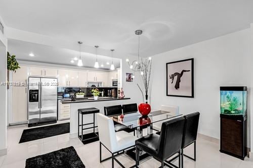 dining area with a notable chandelier and light tile patterned floors