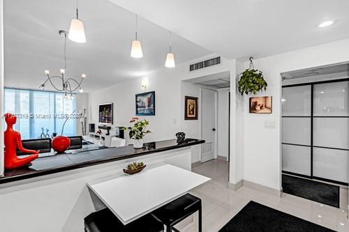 kitchen with light tile patterned floors and decorative light fixtures