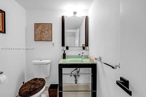 bathroom featuring vanity and toilet