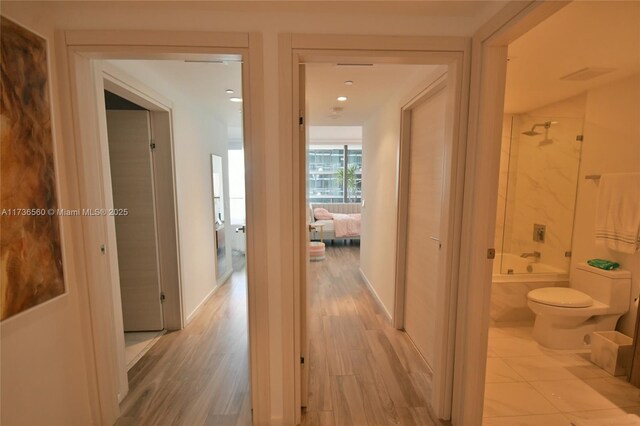 hall with light hardwood / wood-style flooring