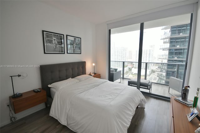 bedroom with dark hardwood / wood-style flooring and floor to ceiling windows