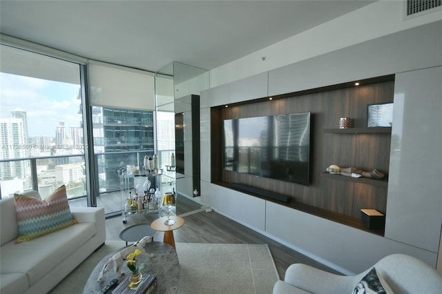 living room featuring dark hardwood / wood-style flooring and a wall of windows