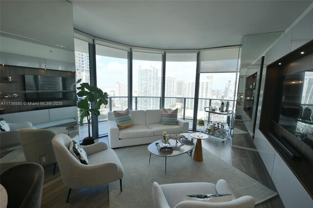 living room with expansive windows and wood-type flooring