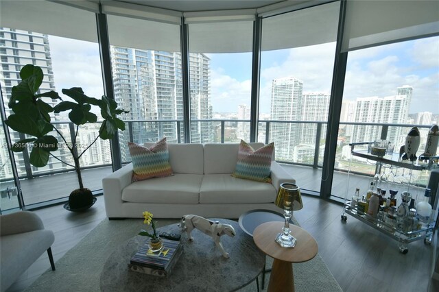 living room with hardwood / wood-style floors and floor to ceiling windows