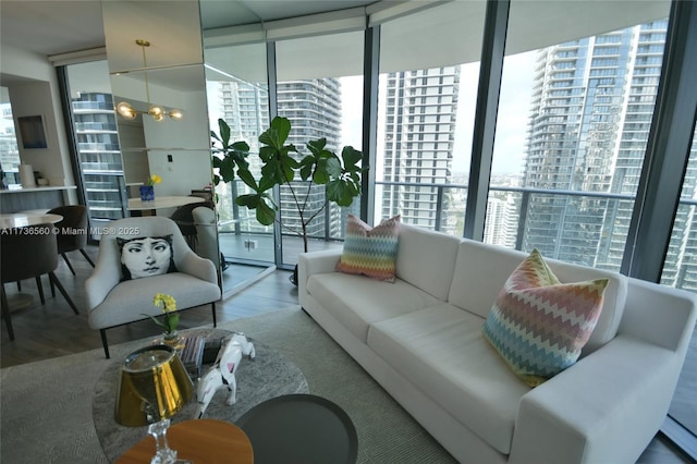 living room featuring hardwood / wood-style flooring and a wall of windows