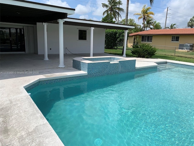 view of pool featuring an in ground hot tub and a patio area