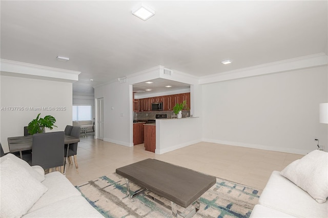 living room with ornamental molding and light tile patterned floors