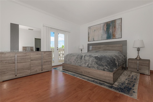 bedroom featuring ornamental molding, dark wood-type flooring, access to exterior, and french doors