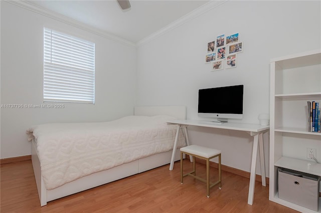 bedroom featuring hardwood / wood-style flooring, ceiling fan, and crown molding