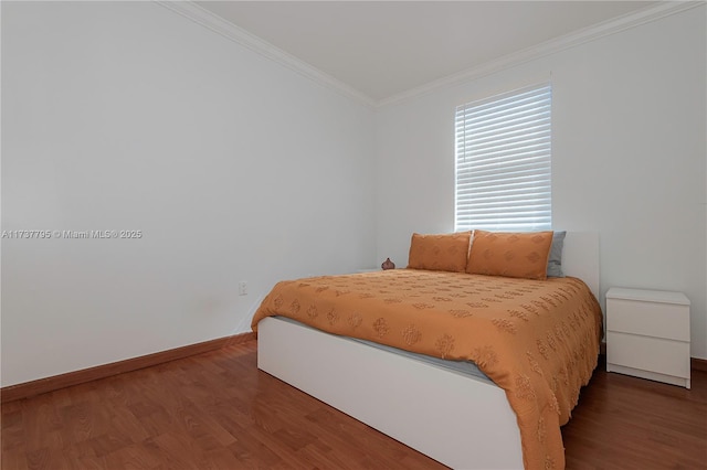 bedroom featuring crown molding and dark hardwood / wood-style floors