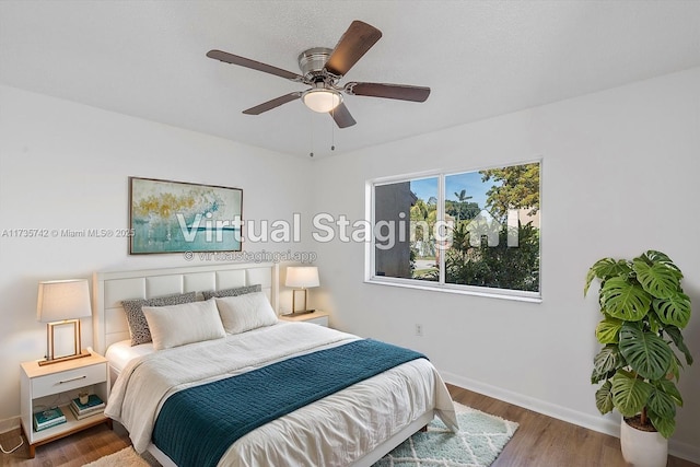 bedroom featuring dark hardwood / wood-style flooring and ceiling fan