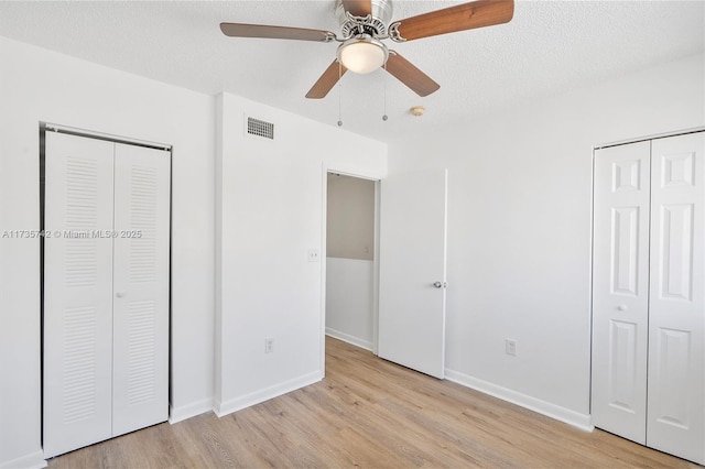 unfurnished bedroom featuring ceiling fan, light hardwood / wood-style flooring, and a textured ceiling